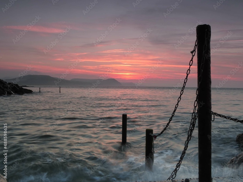 beautiful sunrise over the sea at Lyme Regis Dorset England	
