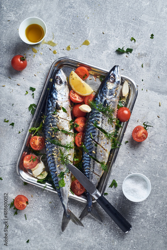Mackerel fish prepared to cook in oven with spices tomatoes lemon and garlic. Mediterranean style to cook mackerel fish in oven.