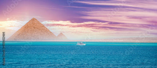 Fotografía Sunset red sea with white yacht background egyptian pyramid Cairo, Egypt
