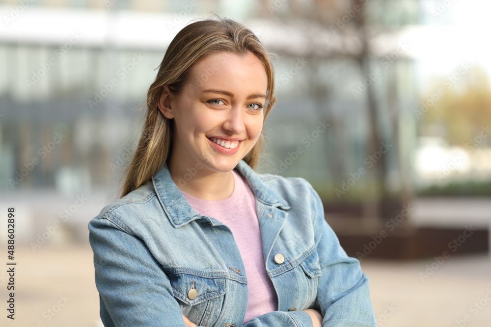 Happy teen posing looking at camera standing in the street Happy teen posing looking at camera standing in the street