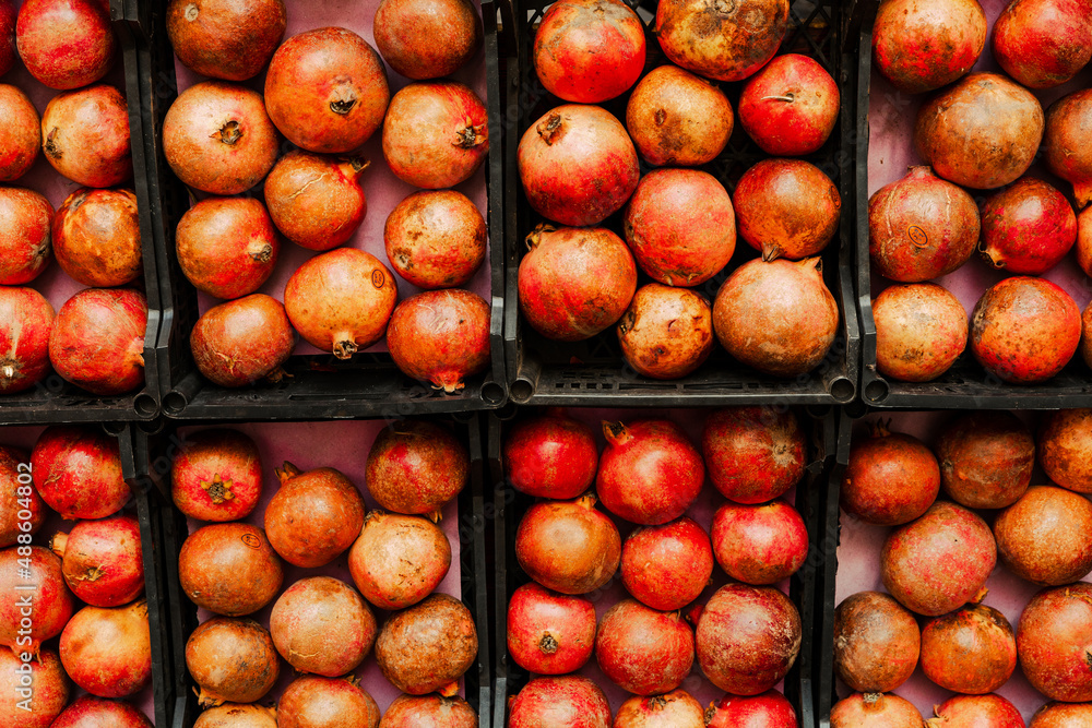 Ripe pomegranate fruit rows on the farmers market Ripe pomegranate fruit rows on the farmers market