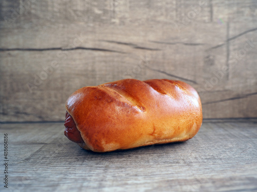 sausage in dough on wooden background