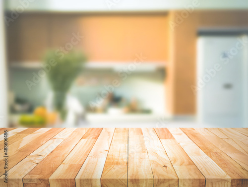 Selective focus.Wood table top on blur kitchen counter background. © hakinmhan