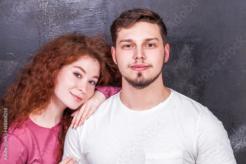 Beautiful red hair girl posing with her boyfriend