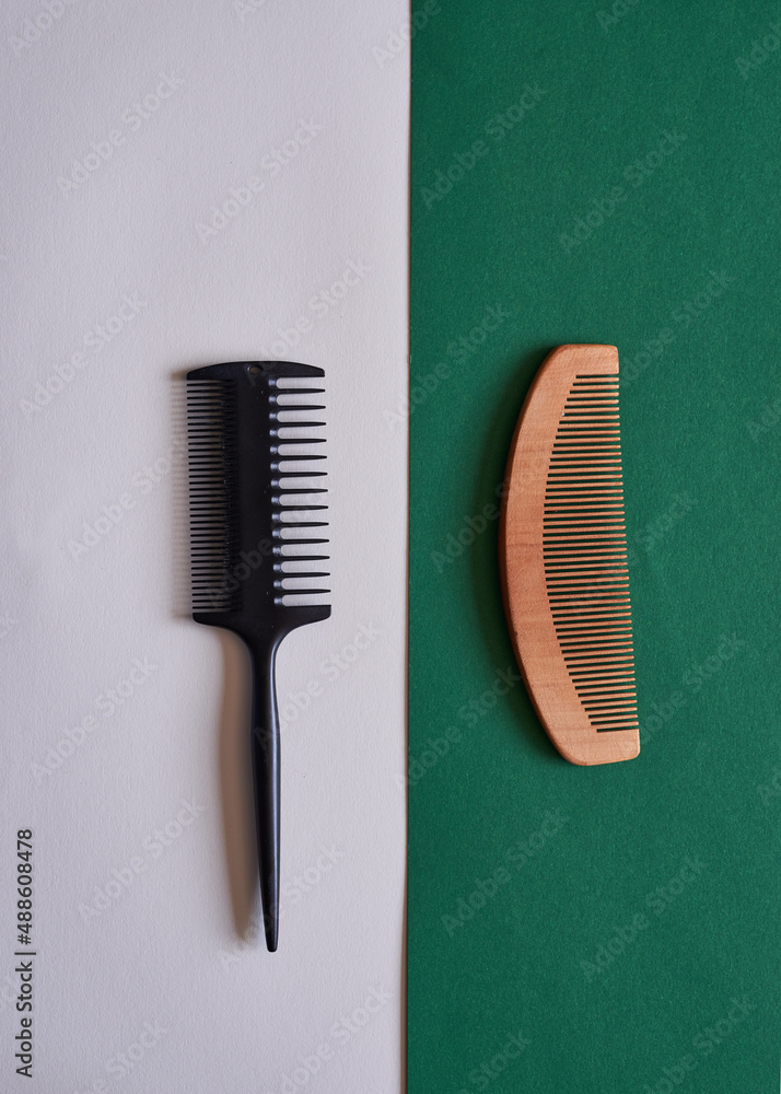 A comparison flat lay of plastic and wooden eco-friendly comb