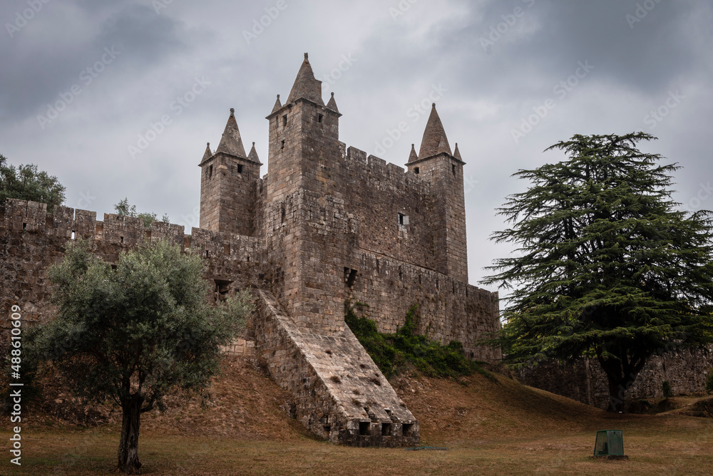 Impressive defensive castle of Santa Maria da Feira, on a hill and under a cloudy sky Impressive defensive castle of Santa Maria da Feira, on a hill and under a cloudy sky