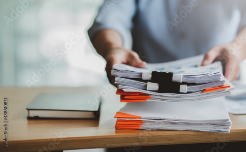 Business Documents, Auditor businesswoman checking searching document legal prepare paperwork or report for analysis TAX time,accountant Documents data contract partner deal in workplace office photo