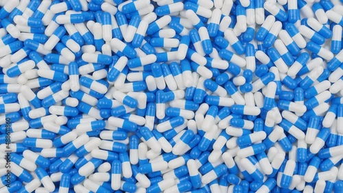 Gelatin capsules. Blue and white pills. A lot of medicines, view from top photo