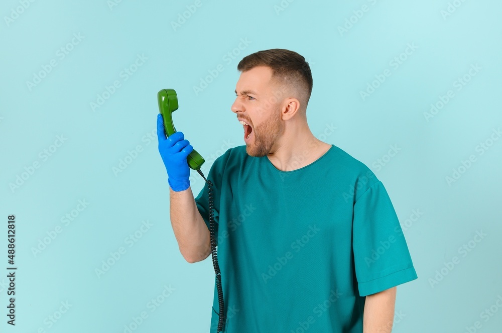 doctor with phone on a blue background. doctor call concept doctor with phone on a blue background. doctor call concept