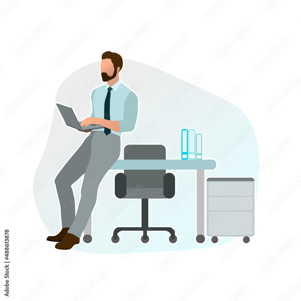 Male manager leaning on the desk in the office with a laptop in his hands Male manager leaning on the desk in the office with a laptop in his hands