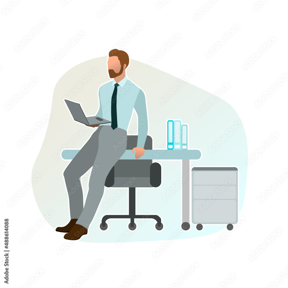 Male manager leaning on the desk in the office with a laptop in his hands Male manager leaning on the desk in the office with a laptop in his hands
