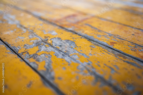 Old boards with cracked yellow paint. Classic rustic background.