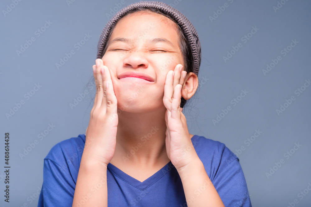 Portrait of eleven years old child with an adorable act in studio