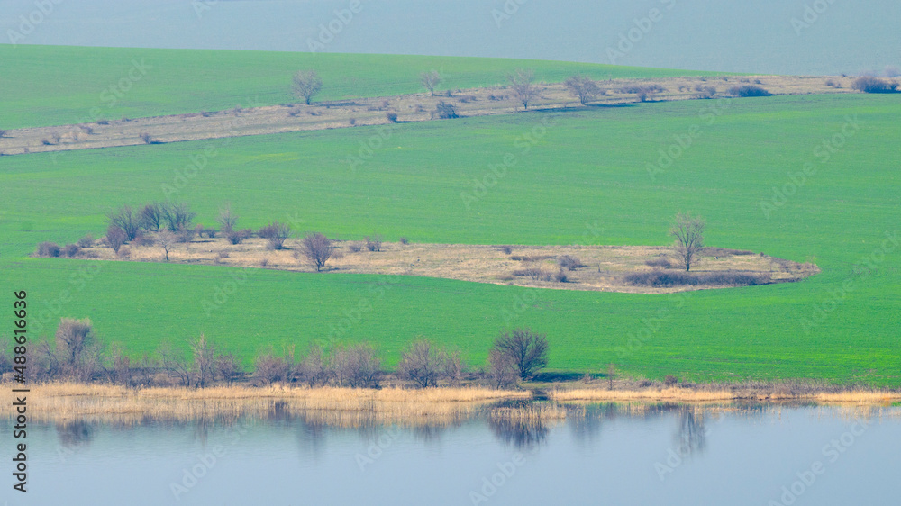 Panoramic view of green fields and hills in spring in Tuscany. Panoramic view of green fields and hills in spring in Tuscany.