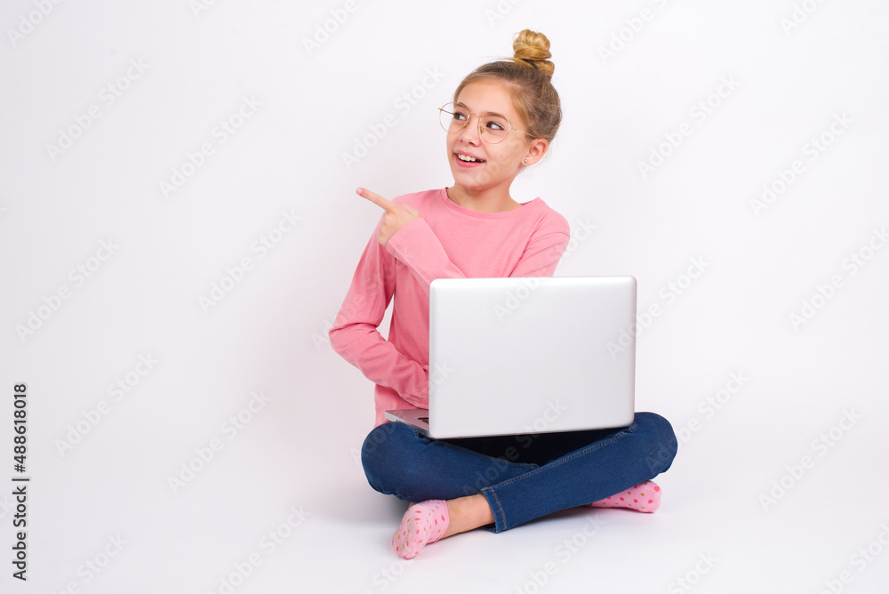 caucasian teen girl sitting with laptop in lotus position on white background glad cheery demonstrating copy space look novelty caucasian teen girl sitting with laptop in lotus position on white background glad cheery demonstrating copy space look novelty