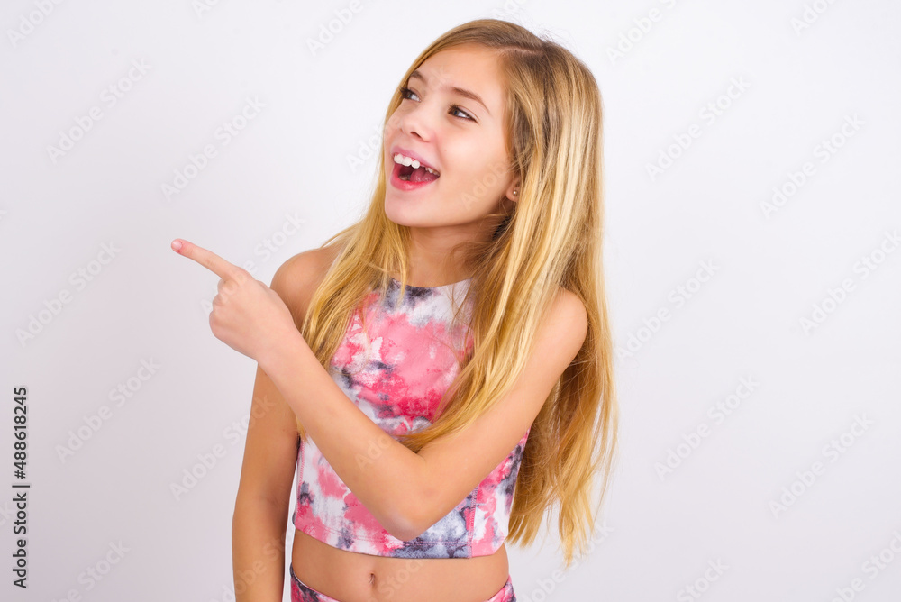 little caucasian kid girl wearing sport clothing over white background glad cheery demonstrating copy space look novelty little caucasian kid girl wearing sport clothing over white background glad cheery demonstrating copy space look novelty