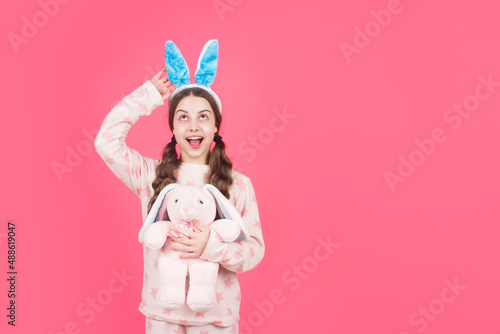 happy easter holiday. funny child in rabbit ears. surprised teenage girl in sleepwear. bunny hunt