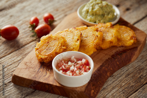 Canvastavla Patacones or tostones, typical Ecuadorian appetizer that consists on fried green plantain slices