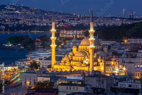 Mahya is among the minarets of Eminonu New Mosque during Ramadan. Among the minarets of the New Mosque, "Fasting and find health" is written on the ridge. Istanbul Landscape in Ramadan.