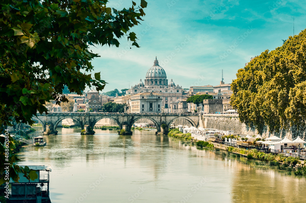 One of the many bridges in Rome over the river Tiber with St Marks Basilica in the distance