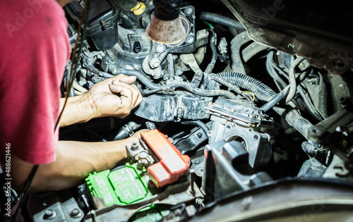 Mechanic Repairing Car Engine