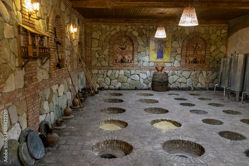 Kveri wine cellar in georgia. Wine storage is a special production of alcohol in the wine industry. Stone floor. Hole in the ground. Wine production in the winery. Georgian wine. Wine production. photo