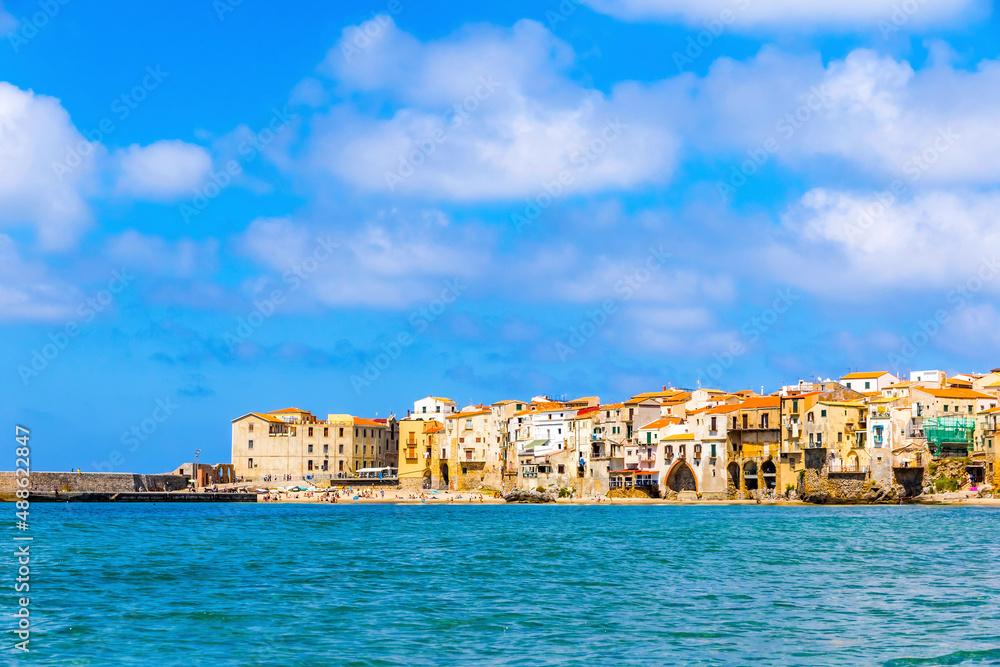 Picturesque summer view of Cefalu beach, Cefalu town, Sicily, Italy. Cefalu has a long and lovely beach with clean, golden sand. Is one of the best in Sicily