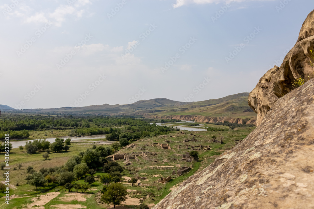 View from the ancient cave city of Uplistsikhe overlooking the Mtkvari river, in the Shida Kartli Region of Georgia, Caucasus, Eastern Europe. Church of the Prince at Uplistsikhe. Near Gori.Historical View from the ancient cave city of Uplistsikhe overlooking the Mtkvari river, in the Shida Kartli Region of Georgia, Caucasus, Eastern Europe. Church of the Prince at Uplistsikhe. Near Gori.Historical