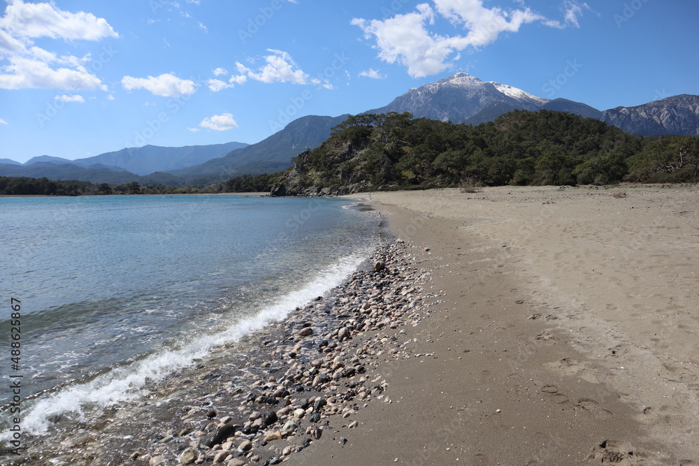 breathtaking spring view of the snow-capped top of the mountain Tahtali fron the beach in Phaselis, Turkey breathtaking spring view of the snow-capped top of the mountain Tahtali fron the beach in Phaselis, Turkey