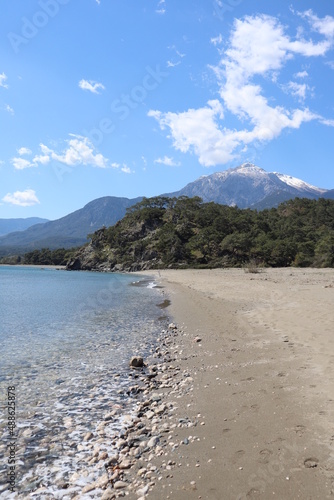 breathtaking spring view of the snow-capped top of the mountain Tahtali fron the beach in Phaselis, Turkey