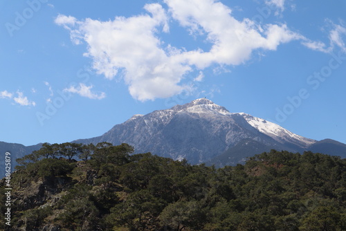 breathtaking spring view of the snow-capped top of the mountain Tahtali fron the beach in Phaselis  Turkey