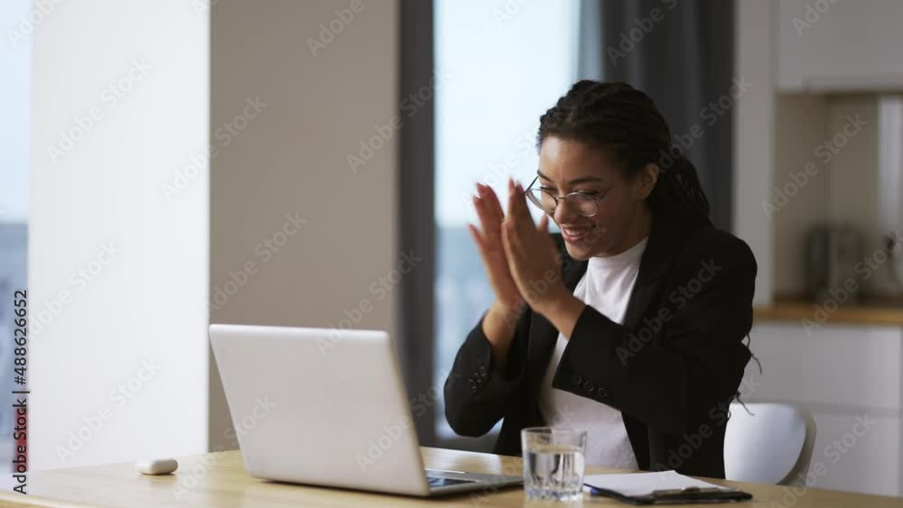 Pretty african business woman working in office on successful project Pretty african business woman working in office on successful project