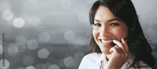 Contact me for quick, reliable, and friendly service. Cropped portrait of a friendly female support agent working in an office against a digitally enhanced background.