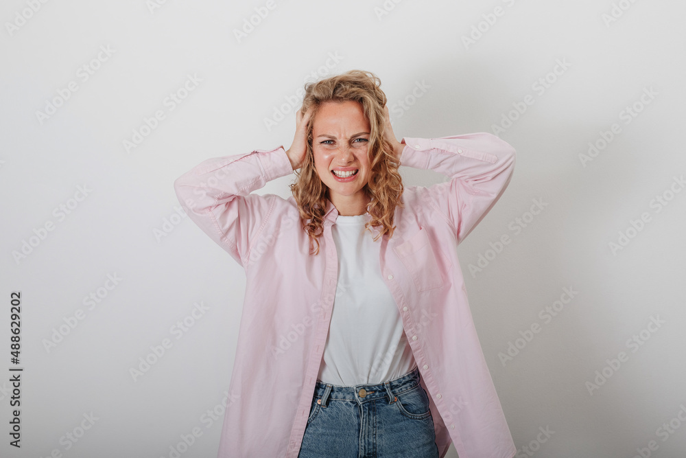 A girl with a headache, anger, not understanding, holding her head A girl with a headache, anger, not understanding, holding her head