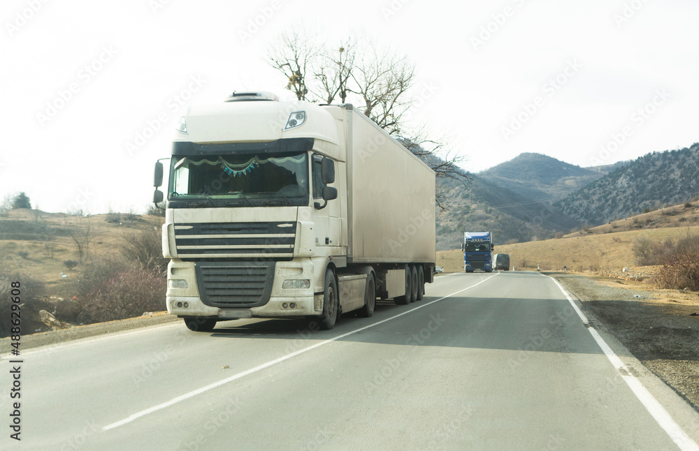 White semi trailer lorry truck passing highway driving