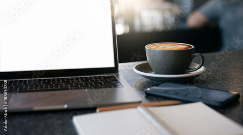 Work from home  desk office with laptop  blank notepad  mobile phone and coffee cup on desk