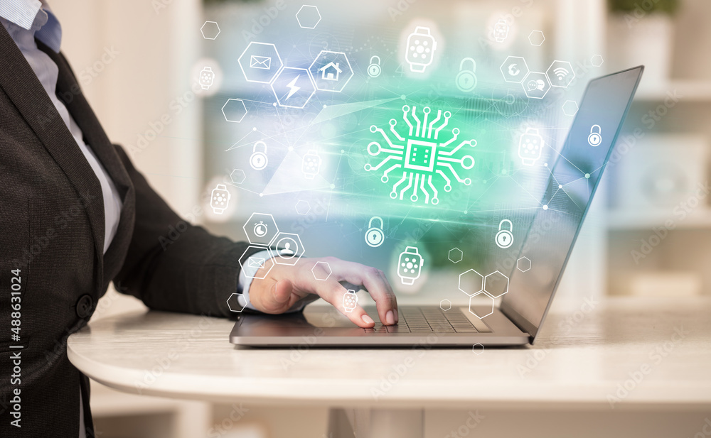 Hands working on laptop with digital icons Hands working on laptop with digital icons