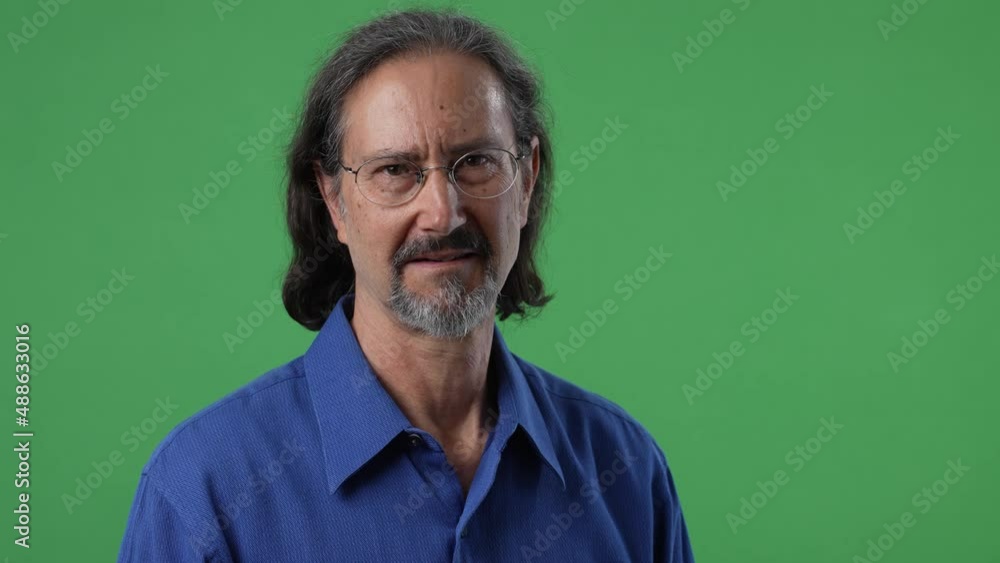 Portrait of mature man smiling happy face on green screen chroma key background in business shirt. Portrait of mature man smiling happy face on green screen chroma key background in business shirt.