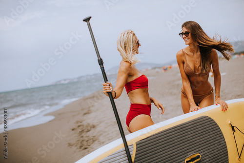 Two young women with paddle...