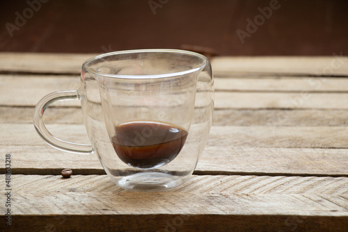 an empty coffee cup on an old wooden table in the morning at home
