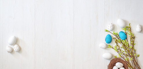 Branches with green leaves and easter eggs on a light background. Happy easter flat lay concept