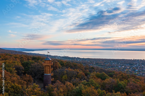 Aerial view about the freshly renovated lookout tower at Révfülöp. Lake Balaton and cloudy autumn sunrise at the background. Hungarian name is Fülöp-hegyi Millenniumi kilátó. photo