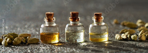 Bilde på lerret Banner with essential oil bottles and cardamon pods
