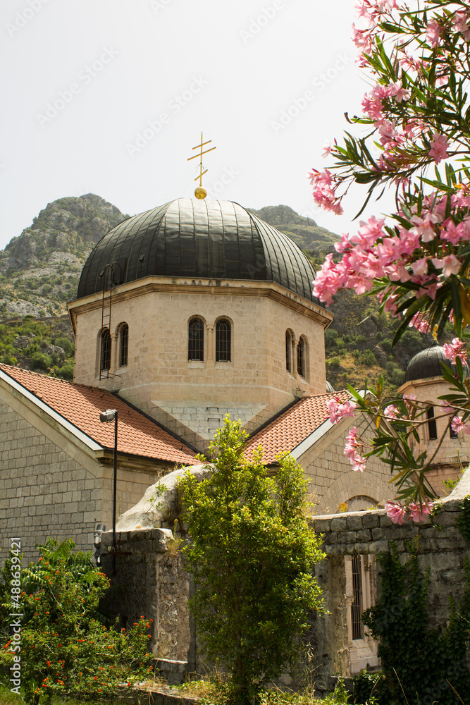 View of the old church and mountains on a summer day. Kotor. Montenegro. Location vertical.