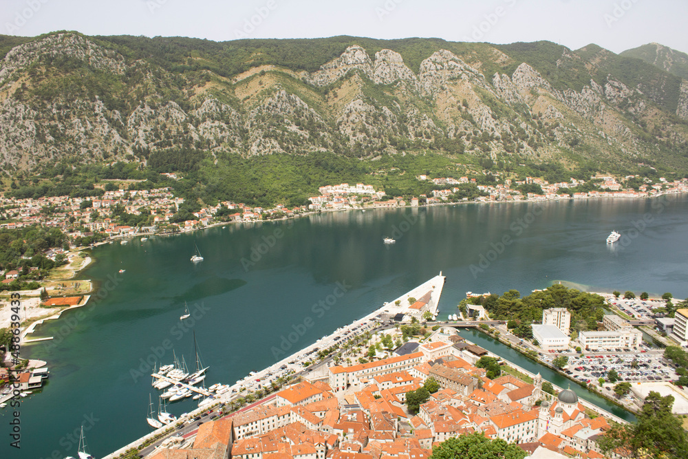 Top view of old city houses and embankment on a summer day. Kotor. Montenegro.