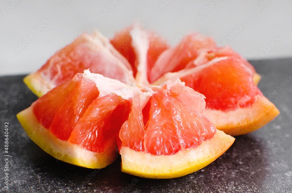 broken red grapefruit close-up. Lots of vitamins in fruits. Healthy food. broken red grapefruit close-up. Lots of vitamins in fruits. Healthy food.