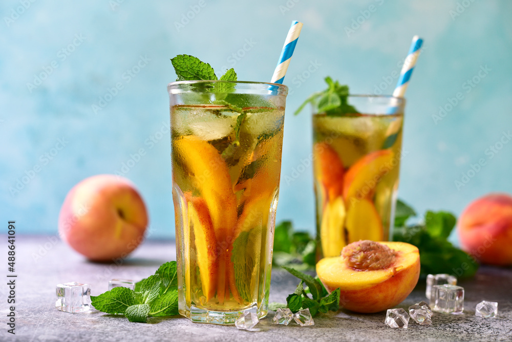 Fototapeta premium Cold summer delicious peach tea in a tall glasses.