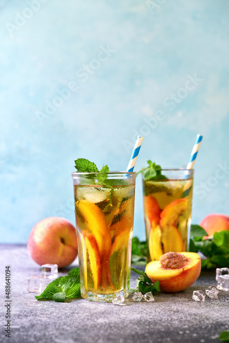Cold summer delicious peach tea in a tall glasses.