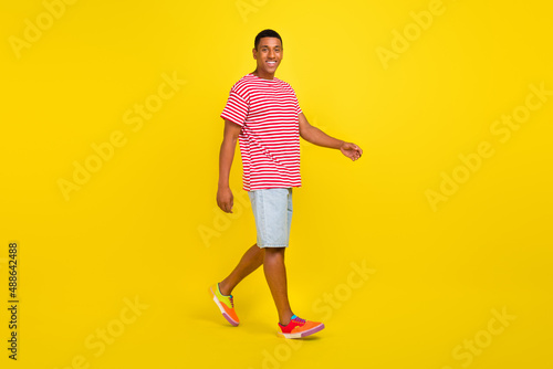 Full length profile side photo of guy go date with his girlfriend isolated over bright yellow color background © deagreez