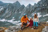Family vacations in mountains travel adventure parents hiking with kid camping outdoor active healthy lifestyle father and mother with daughter enjoying landscape view